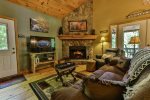 Stone floor to ceiling fireplace to cozy up around
